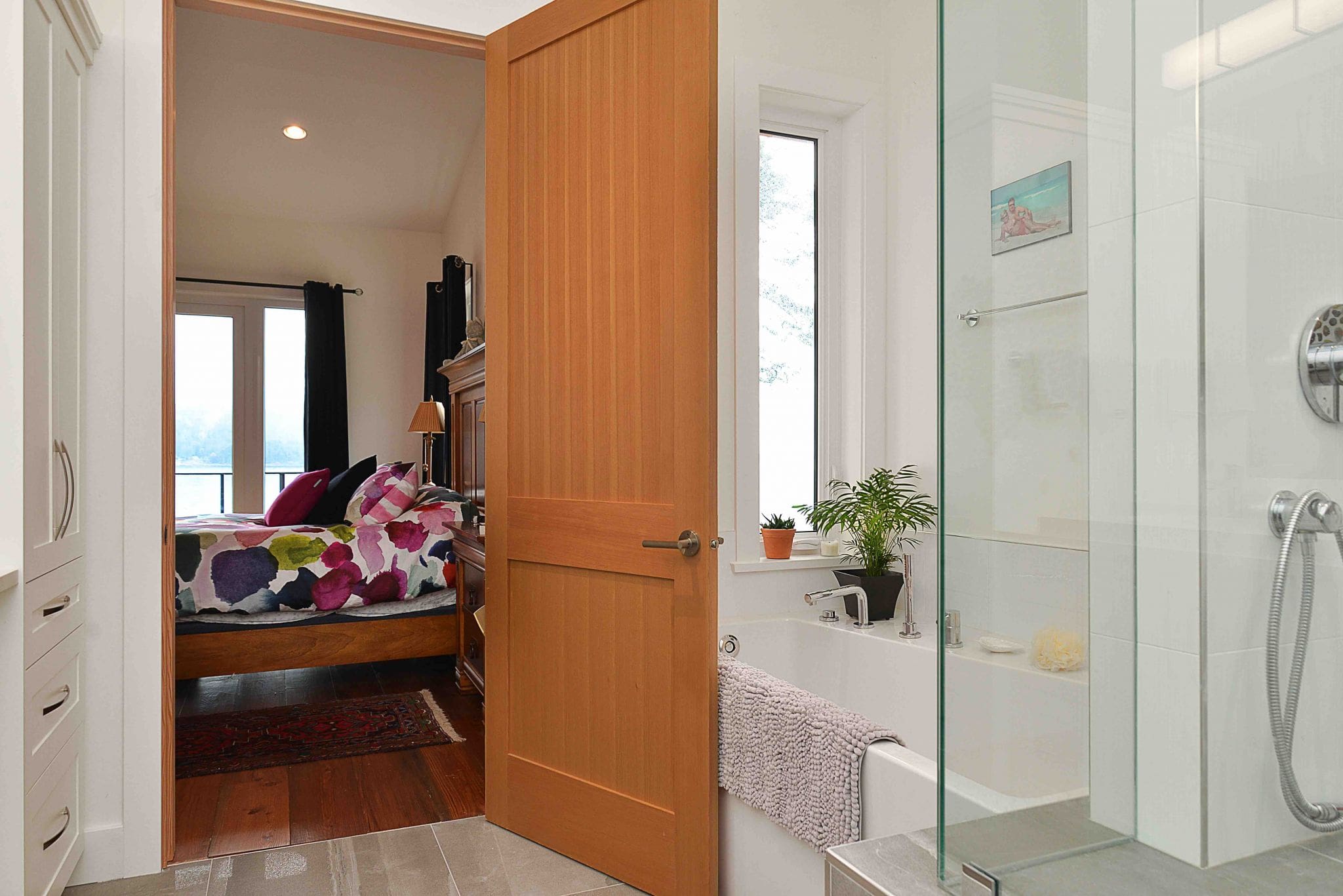 Pender Harbour Timber Frame Home | Streamline Design Ltd Looking into the bedroom from the bathroom