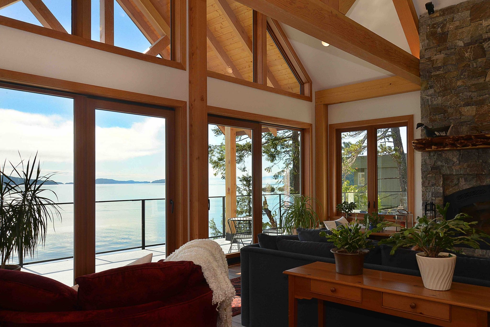 Pender Harbour Timber Frame Home | Streamline Design Ltd Exposed beams and rock fireplace