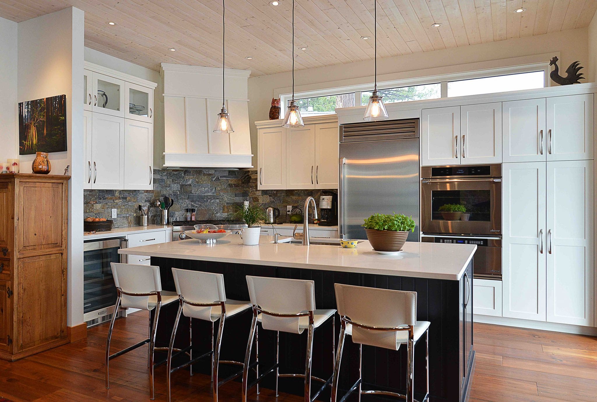 Pender Harbour Timber Frame Home | Streamline Design Ltd Modern kitchen with island and four chairs
