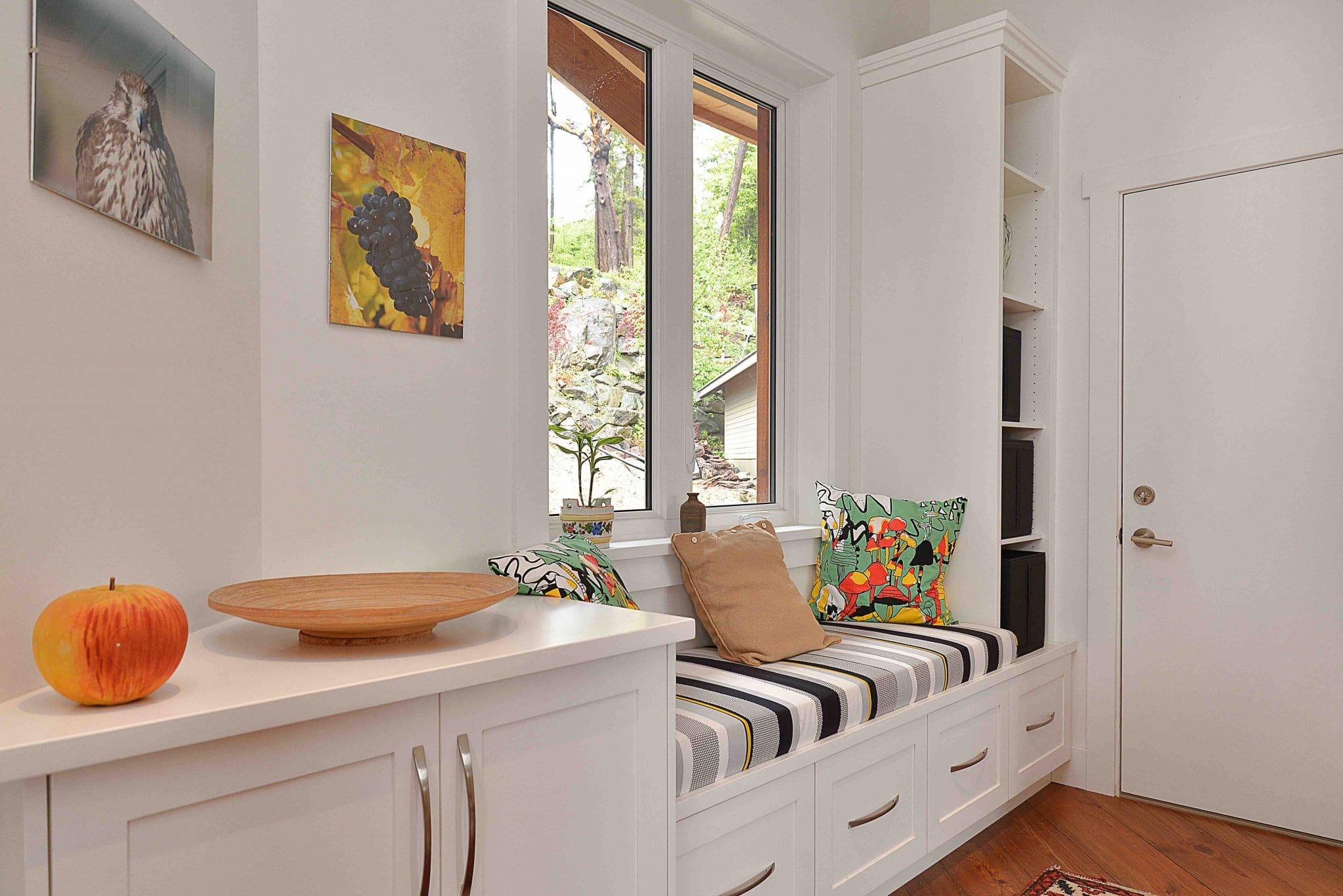 Pender Harbour Timber Frame Home | Streamline Design Ltd Sitting area bench with colourful cushions