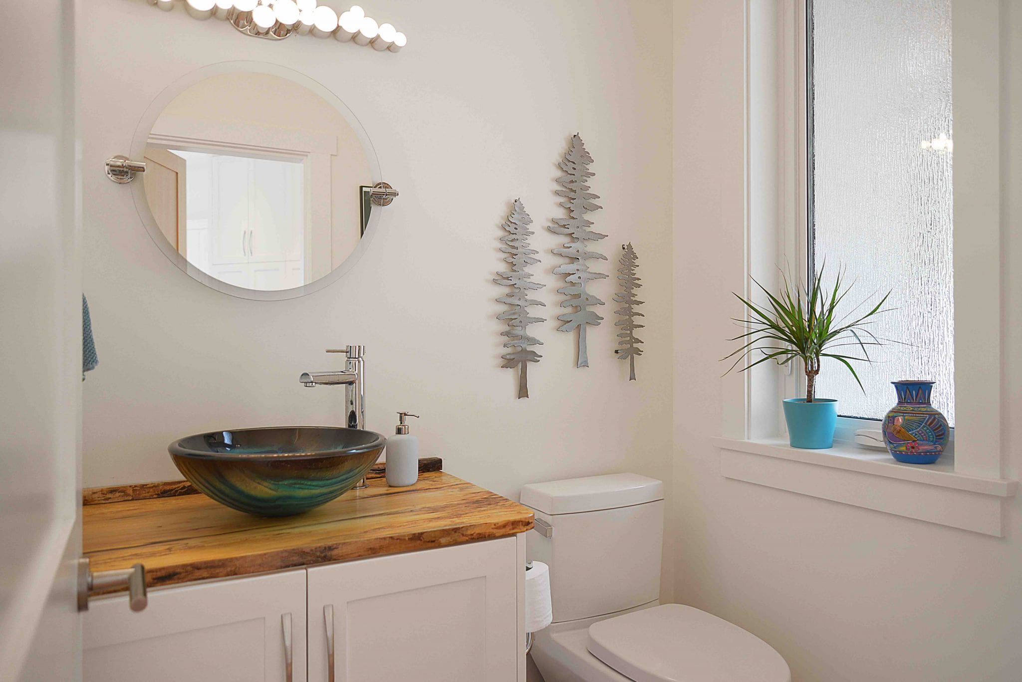 Pender Harbour Timber Frame Home | Streamline Design Ltd Bathroom with modern sink and wall decorations