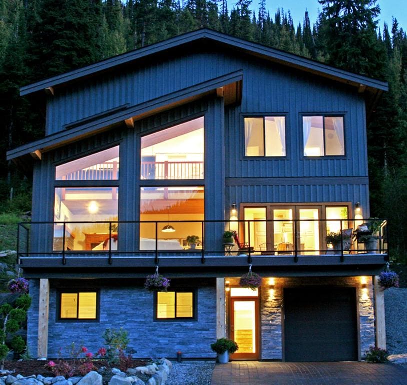 Timber Wolf Bed and Breakfast Timber Frame Design 2 | Streamline Design Ltd Outside of a timber frame home in the dark