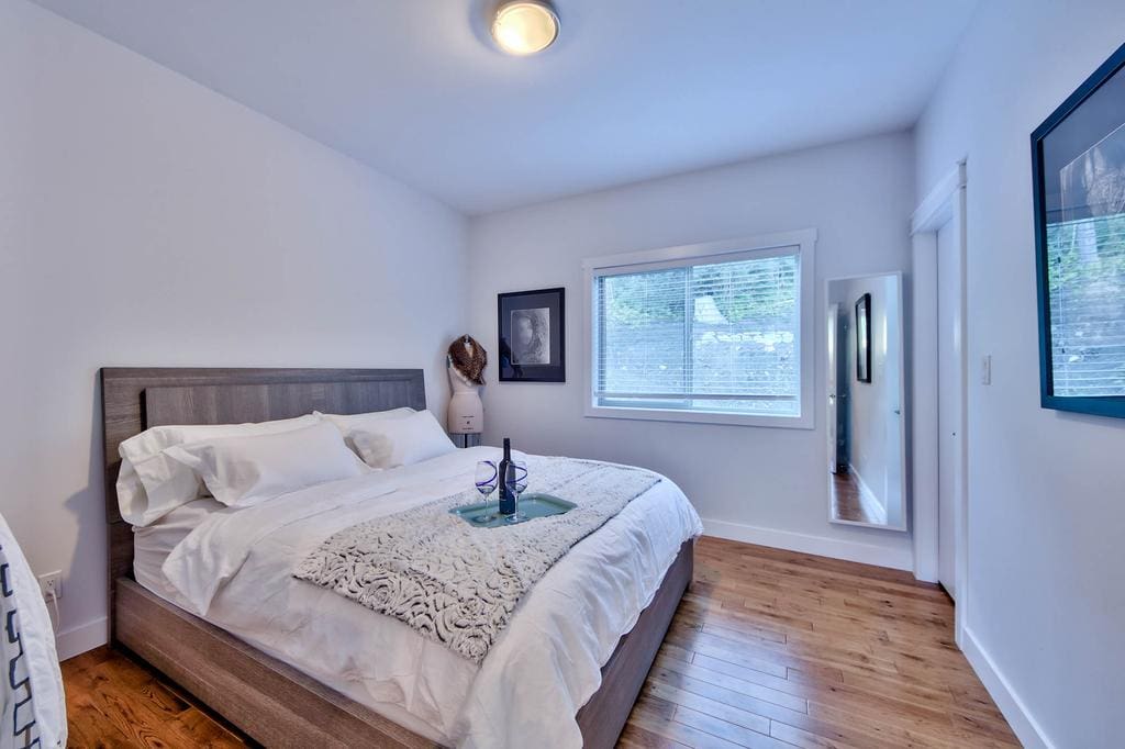 Timber Wolf Bed and Breakfast Timber Frame Design 8 | Streamline Design Ltd Second bedroom with wood floor in modern home